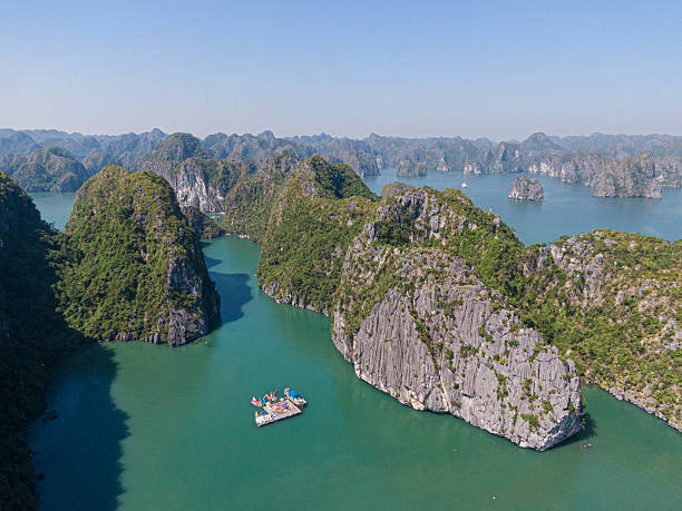 istock Floating kayak platform surrounded by limestone peaks in Ha Long Bay, Vietnam (drone view) 2207019640