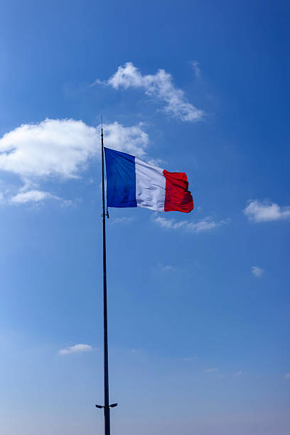 istock French flag in a blue sky background 2207021562