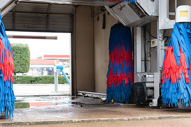 A drive thru car wash at a gas station.
