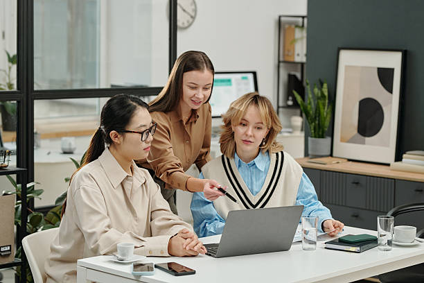 istock Smiling Female Manager Using Laptop at Work Meeting 2207021894