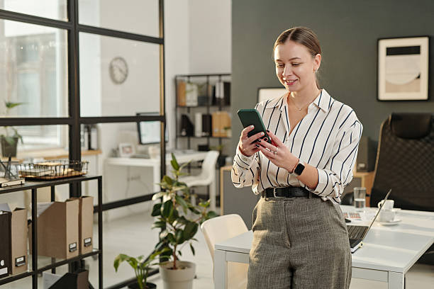 istock Businesswoman Using Phone in Office 2207022000