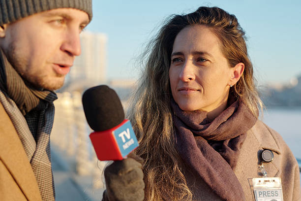 Senior man news reporter in live broadcasting. TV reporter presenting the news outdoors.