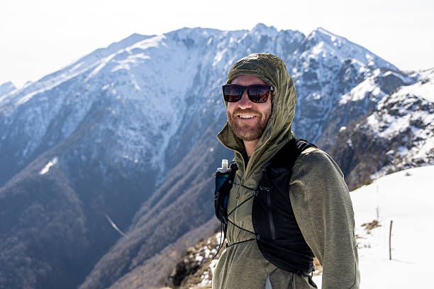 istock Smiling Hiker Exploring Snowy Mountain Landscape 2207024332