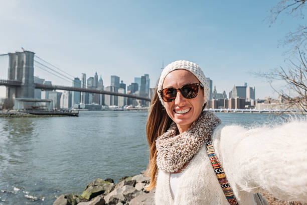 istock Woman Taking Selfie with City Skyline Background 2207025434