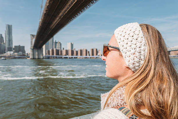 istock Woman Relaxing by Waterfront with Cityscape View 2207025445