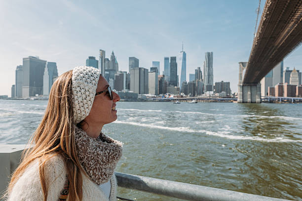 istock Woman Relaxing by Waterfront with Cityscape View 2207025453