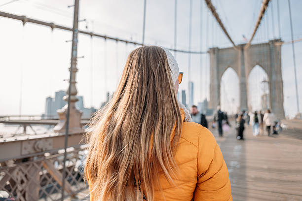 istock Woman Enjoying a Walk on Brooklyn Bridge 2207025615