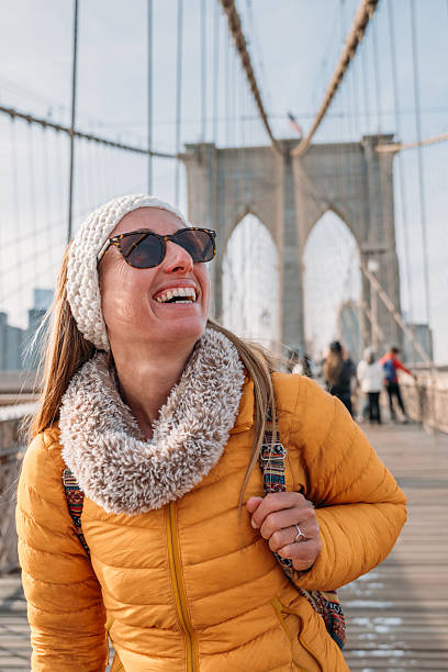 istock Woman Enjoying a Sunny Day on Brooklyn Bridge 2207025620