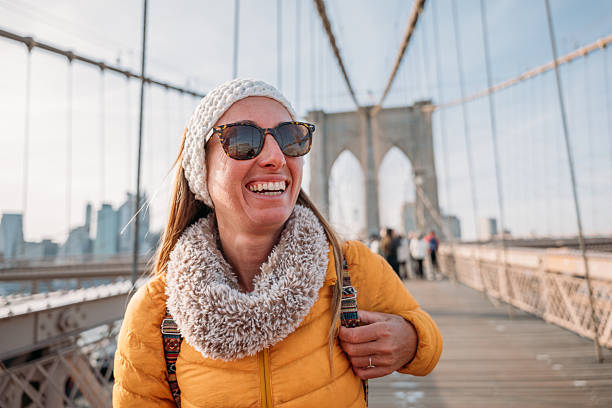 istock Woman Enjoying a Sunny Day on Brooklyn Bridge 2207025621