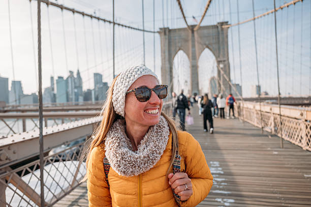 istock Woman Enjoying a Sunny Day on Brooklyn Bridge 2207025627
