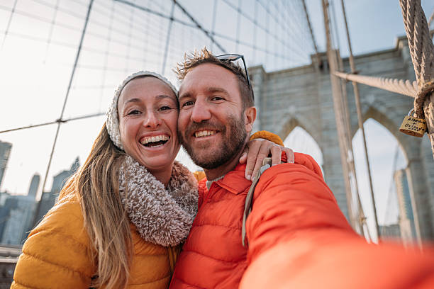 istock Happy Couple Taking Selfie on Iconic Suspension Bridge 2207025661