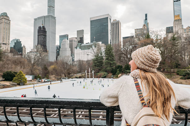 View of Central Park in front of Wollman rink with Manhattan buildings in rear view.