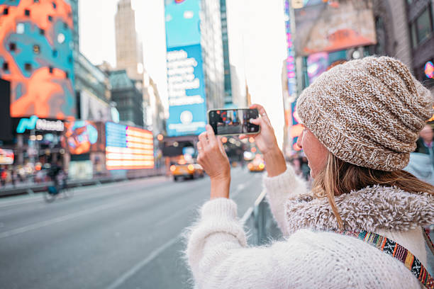 istock Tourist Capturing Vibrant Times Square on Smartphone 2207025773
