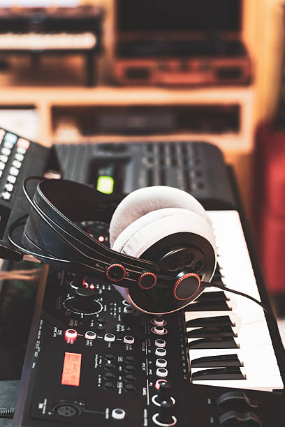istock headphone on synthesizer keyboard in home studio. recording concept 2207027740