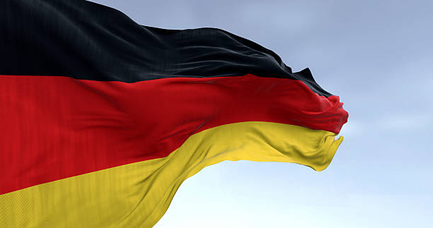 istock Germany national flag waving in the wind on a clear day 2207029062