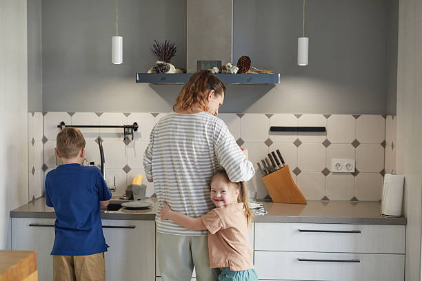 istock Single Mother with Two Kids in Kitchen 2207030006
