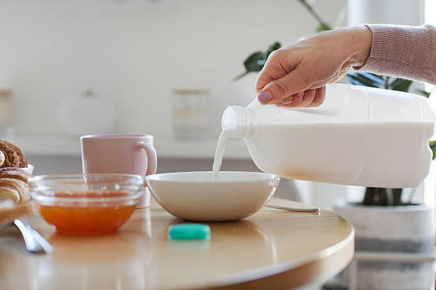 istock Woman Pouring Milk to Cereal 2207030033