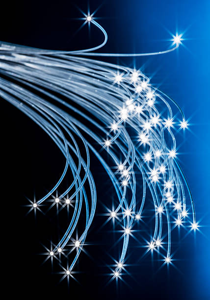 istock Bundle of optical fibers with lights in the ends. Blue background. 2207030255