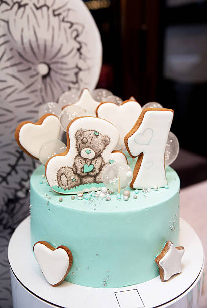 istock Birthday cake with a bear and heart-shaped cookies 2207031803