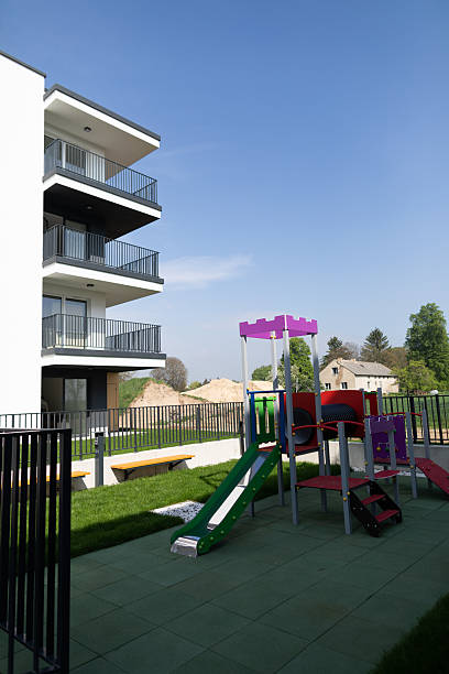 istock Contemporary Apartment Complex Featuring a Safe and Inviting Childrens Playground Area 2207033181