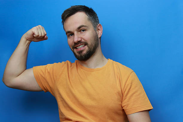 orange blue background positive emotions biceps healthy studio shot