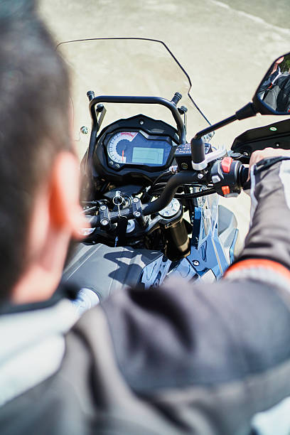 istock Motorcyclist looking at the dashboard of his motorcycle 2207035653