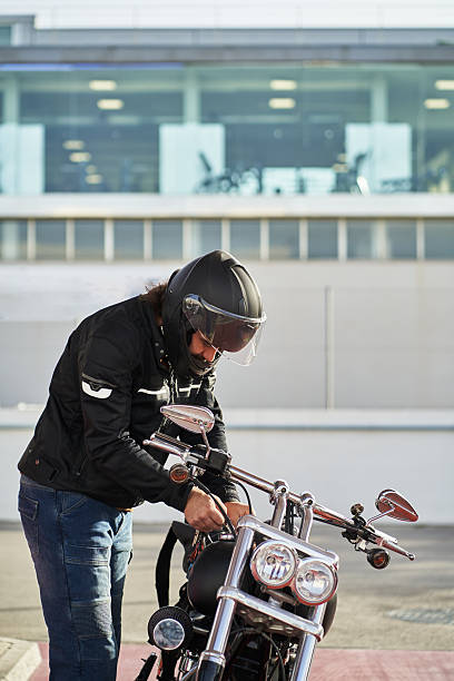 istock Biker fixing his motorcycle outside a building 2207035807