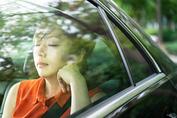 istock Beautiful woman sleeping in a car 2207037854