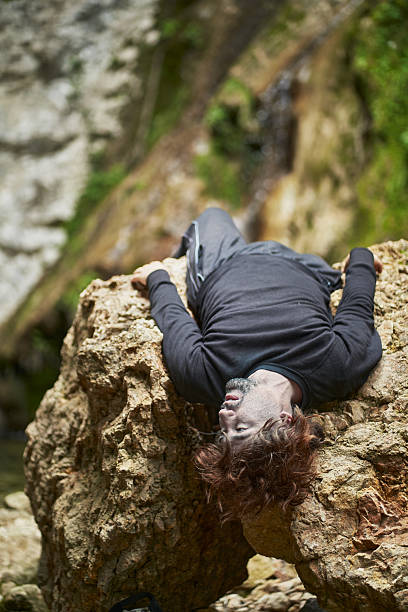istock Injured hiker lying on a rock after falling in the mountains 2207038332