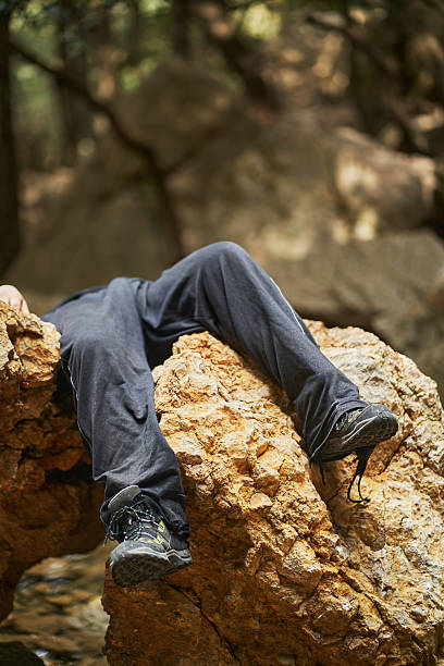 istock Hiker lying inert on a rock after mountain accident 2207038361