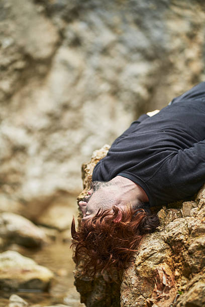 istock Injured hiker lying on rock after mountain accident 2207038398
