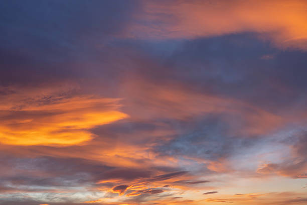 istock Glowing real sky at sunset texture background overlay. Dramatic red and orange clouds. 2207038545