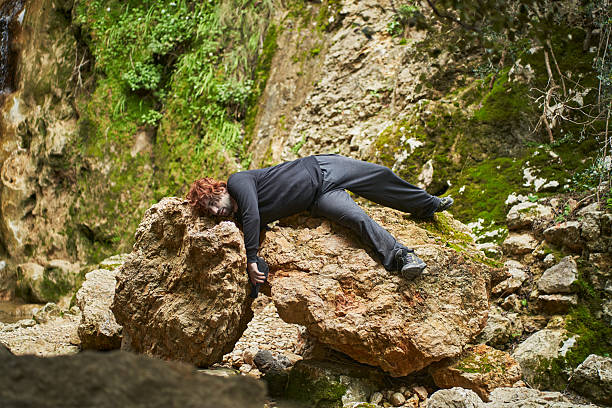 istock Injured hiker lying on a rock after falling in a ravine 2207038651