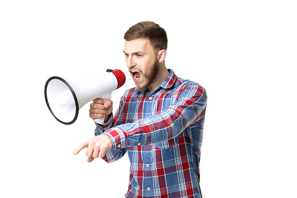istock Young man screaming in megaphone on white background 2207039501