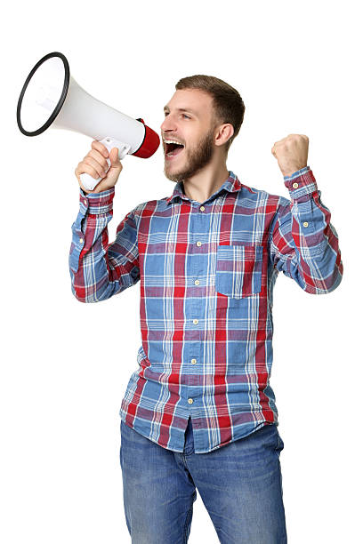 istock Young man screaming in megaphone on white background 2207039545