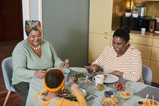 istock Happy African American Family at Dinner Table 2207040043