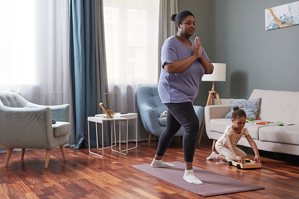 istock Young Mother doing Yoga at Home 2207040103