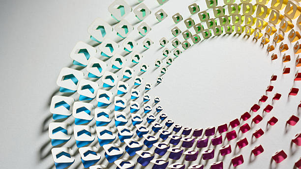 istock Circular paper cut artwork with rainbow gradient arrow shapes on white background in abstract still life composition 2207040406