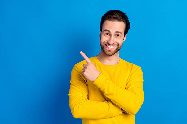 istock Portrait of attractive cheerful brunet guy demonstrating decision copy empty space isolated over bright blue color background 2207040678