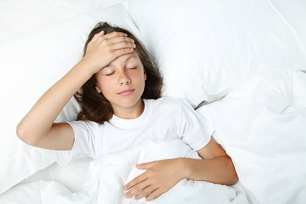 istock Sick girl lying in white bed 2207042601