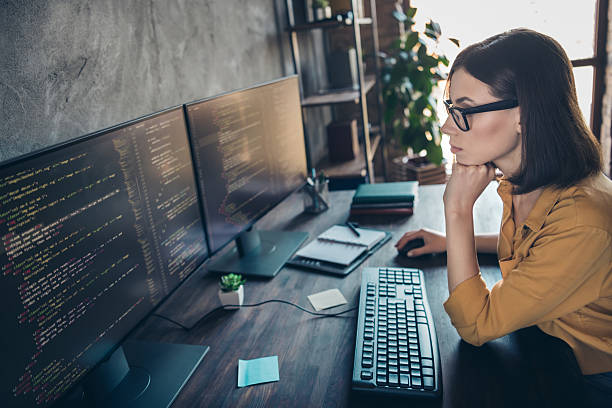 istock Profile side view portrait of attractive clever smart girl cyber engineer analyzing html css php framework at workplace workstation indoors 2207042769