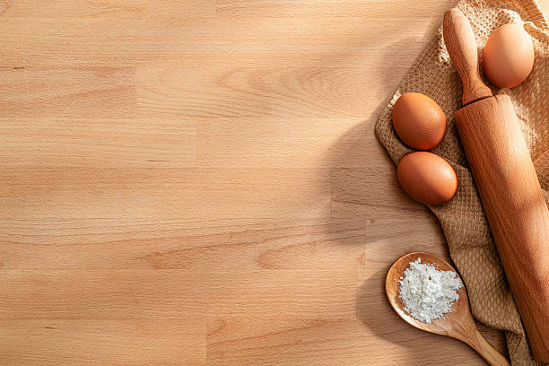Baking background. Rolling pin eggs and flour on wooden table. Copy space