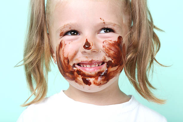 istock Little girl in chocolate on mint background 2207044255