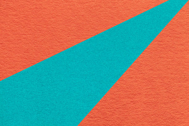 Texture old craft dark orange and turquoise paper background, macro. Structure vintage coral abstract cardboard with blue gradient and rainbow, rays pattern. Felt backdrop.