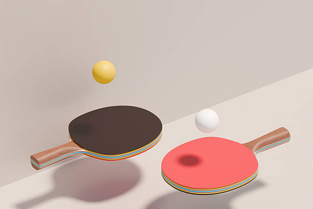 Two table tennis paddles and balls in action, representing a fun game atmosphere. 3d rendering
