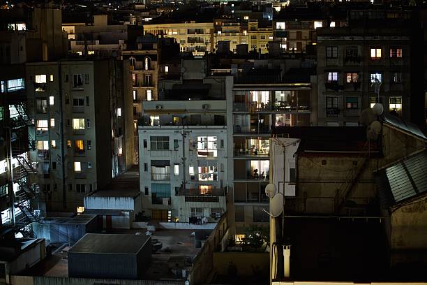 istock Nighttime Cityscape with Illuminated Apartment Windows 2207050125
