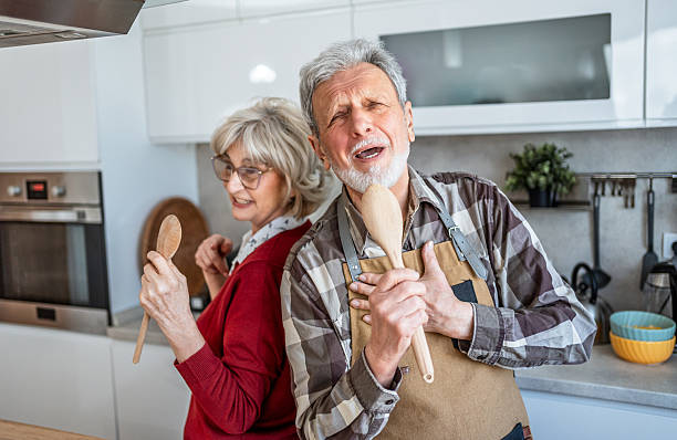 istock Happy elderly couple is having fun in the kitchen 2207055266