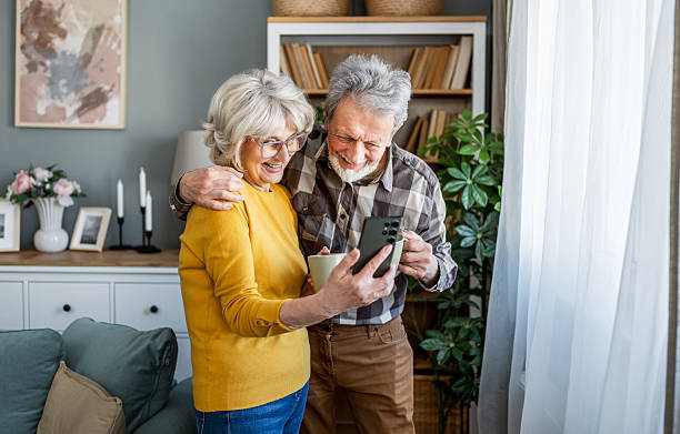 istock Senior couple looking together at mobile phone 2207056618