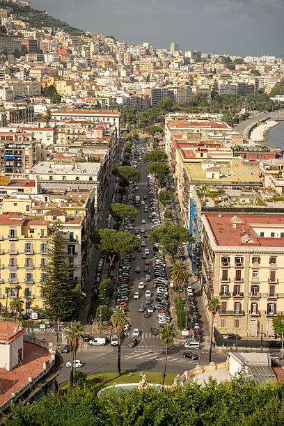istock A panoramic view of Naples from a high vantage point, showcasing the city's densely packed buildings, the shimmering Bay of Naples. 2207059192