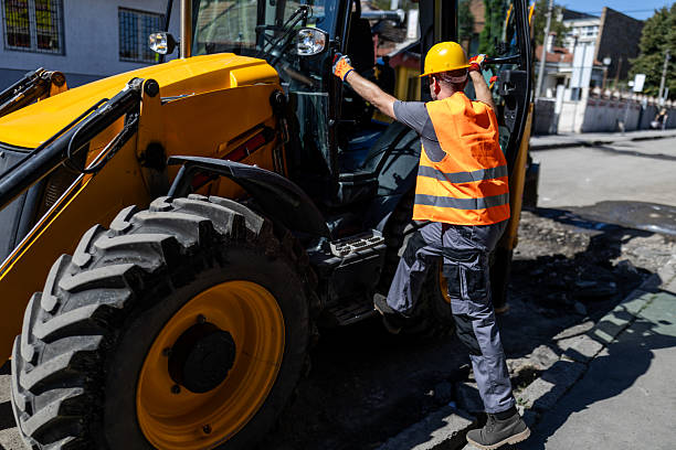 istock Construction worker operating heavy equipment at urban site during daytime 2207061746